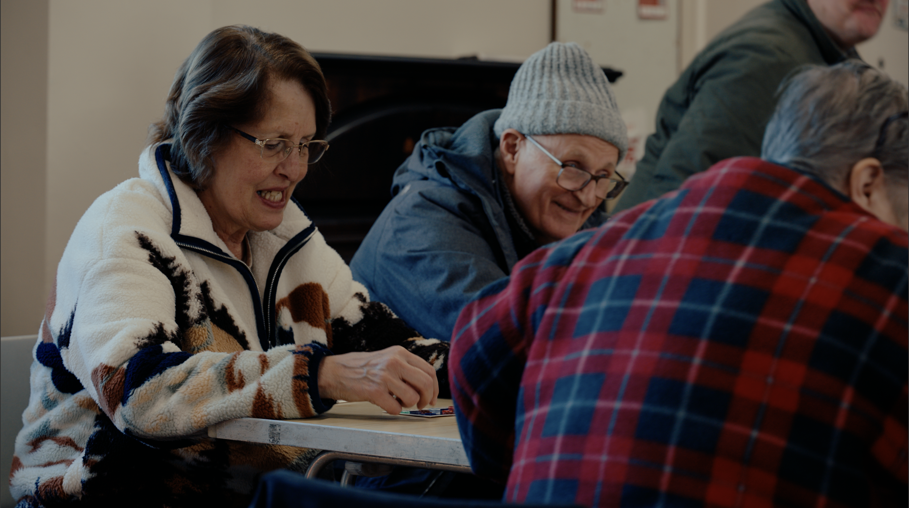 Community navigator supporting someone during a chess activity